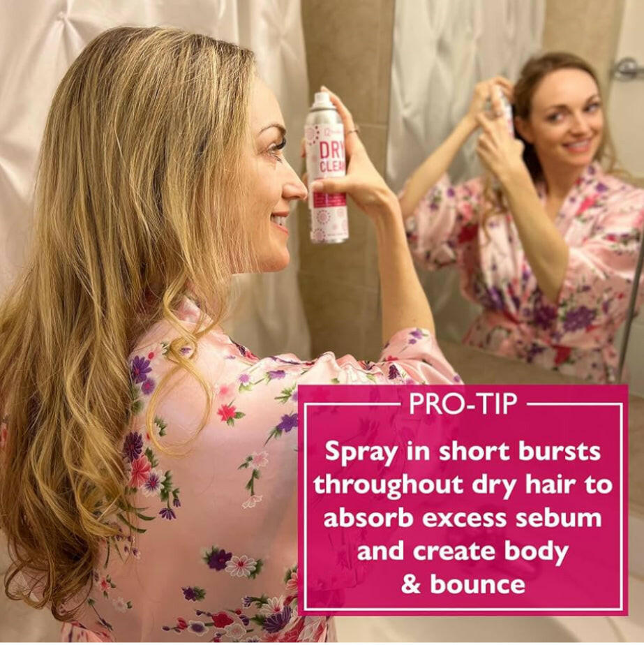 A woman with a can of 12 Benefits Dry Clean dry shampoo with instructions for use listed.