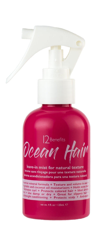 Pink bottle with white spray nozzle labeled '12 Benefits Ocean Hair' on a white background with written words leave-in mist for natural texture 