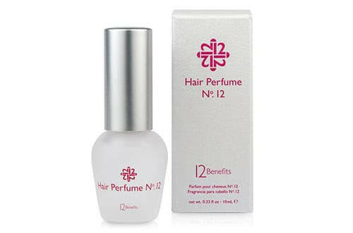 A bottle of Hair Perfume N°12 with its packaging, labeled with '12 Benefits'. The perfume bottle is clear with a white label and red text, and it's placed against a white background.